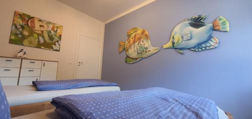 a bedroom with a bed and a fish on the wall at Beautiful Place a Lago d'Orta mit direktem Seezugang in Omegna