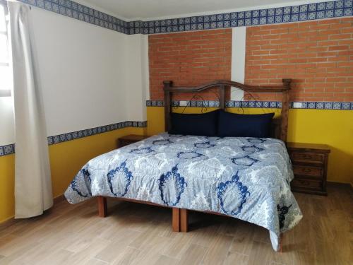 Cama o camas de una habitación en Hotel Y Suites Axolotl