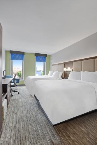 a large hotel room with two beds and a desk at Hotel 1200 in Brooklyn