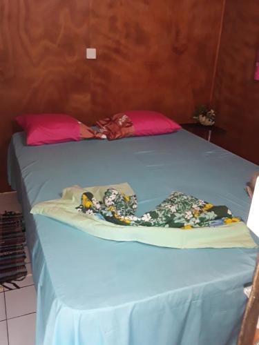 a blue bed with a blue sheet on it at ROYAL Tapo-Tapo in Patio