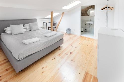 a bedroom with a bed with two towels on it at Room Lusíadas with private bathroom in Lisbon