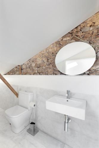 a bathroom with a white sink and a mirror at Room Lusíadas with private bathroom in Lisbon