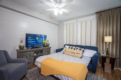 a living room with a bed and a tv at The Grand Sandestin in Destin