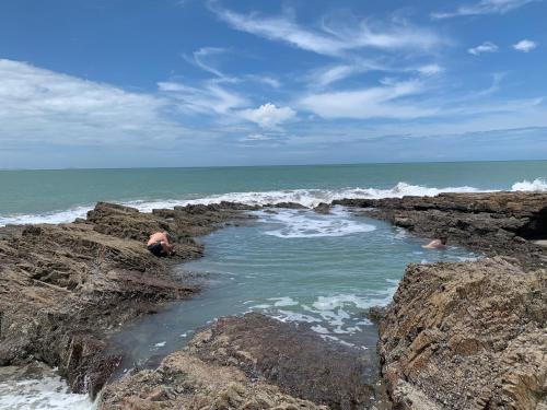 a man laying on the rocks near the ocean at Casa Swell Coronado A unique blend of luxury and nature in the hearth of Coronado in Playa Coronado