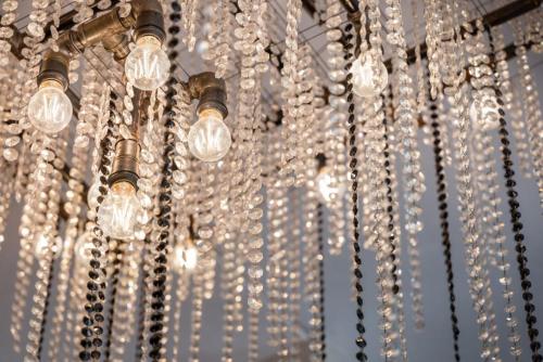 a bunch of lights hanging from a ceiling at Fortune House Hotel Suites in Miami