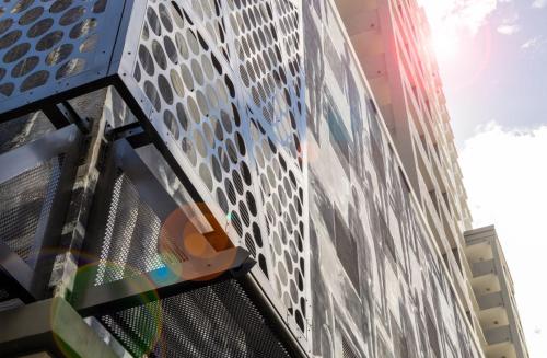 a tall building with a glass facade at Fortune House Hotel Suites in Miami
