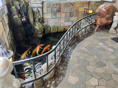 a stairway with a pond in a building at 陶陶居商旅 Tautauchu Hotel in Hualien City