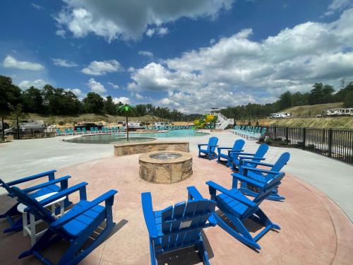 a group of blue chairs in front of a swimming pool at The Lodge at Camp Margaritaville in Pigeon Forge
