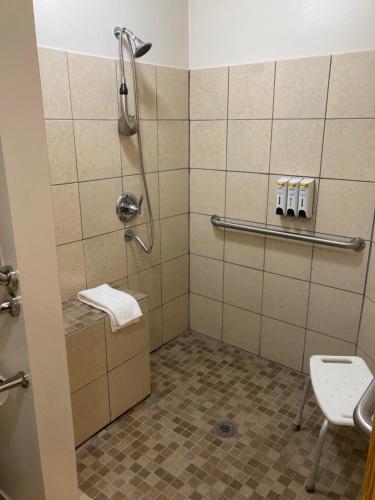 a bathroom with a shower with a toilet and a sink at Super 8 by Wyndham Chisago City in Chisago City