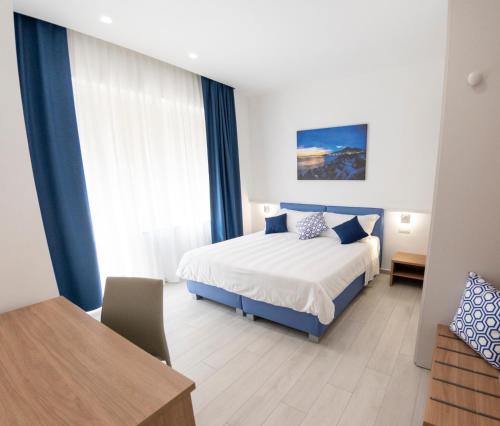 a bedroom with a bed and a desk and a table at Casa Marino in Sorrento