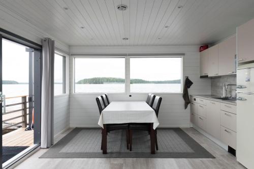 a kitchen with a table and chairs in front of a window at Saunalautta Sisu in Imatra