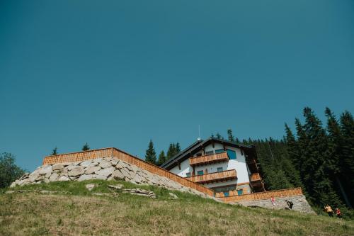 a building on the side of a hill at Cabana Fantanele in Ceahlău