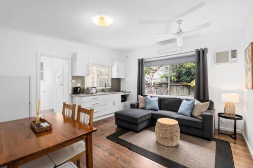 a living room with a couch and a table at Ocean Park Motel & Holiday Apartments in Coffs Harbour