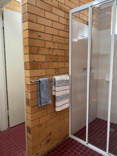 a bathroom with a shower stall and a walk in shower at Pacific Sun Bargara in Bargara