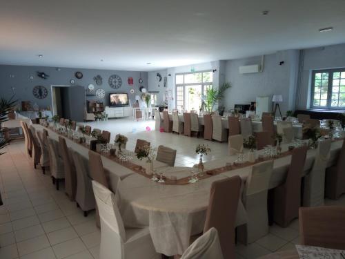 a long table and chairs in a room at Le Domaine de JAUGY in Gièvres