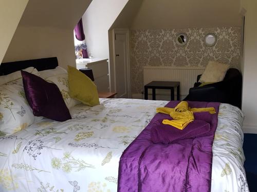 a bedroom with a bed with a robe on it at PEACEFUL RETREAT HIDEAWAY SURREY in Esher