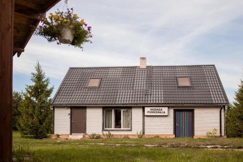 a white house with a sign on it at Hiiemäe Puhkemaja in Kunda