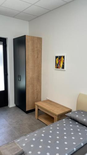 a room with a bed and a wooden cabinet at Simba Apartment B in Smarjeske Toplice