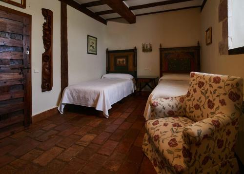 a living room with two beds and a couch at Posada de San Millán in Sepúlveda