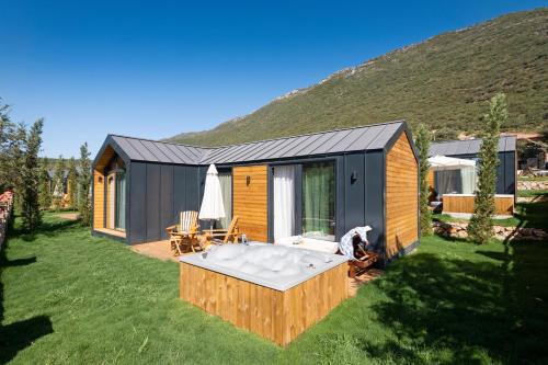 a tiny house with a hot tub in the yard at Kairos Hotel in Kas
