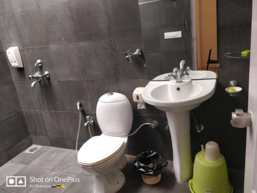 a bathroom with a toilet and a sink at Chalet Casa Amor, Perfect home amidst tranquility in Karjat