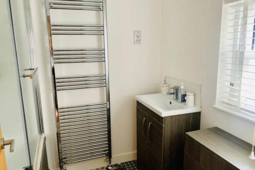 a bathroom with a sink and a mirror at Centrally located luxury 2 bed modern apartment in Great Yarmouth