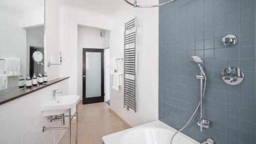 a bathroom with a sink and a toilet and a shower at voco Grand Central Glasgow by IHG in Glasgow