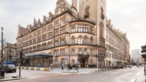 a large building on the corner of a street at voco Grand Central Glasgow by IHG in Glasgow