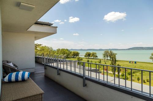 a balcony with a view of the water at Blue Apartments in Balatonlelle