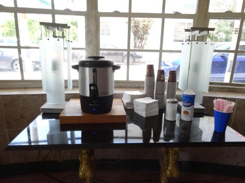 a table with a coffee maker on top of it at James Hotel in Miami Beach