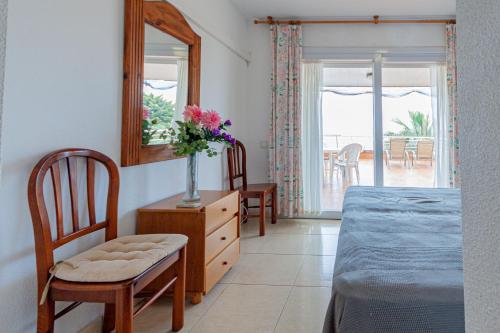 a bedroom with a bed and a dresser with a mirror at Arpon 23c in La Manga del Mar Menor