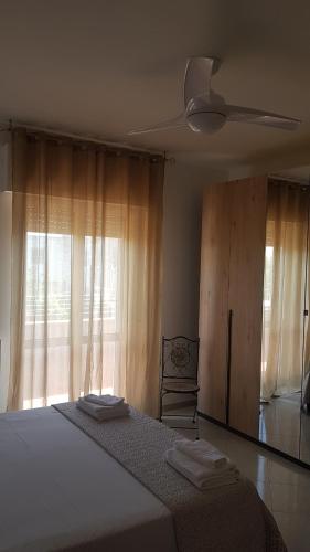 a bedroom with a bed with a fan and a window at B&B Da Pietro in Matera