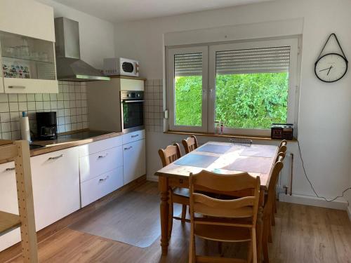 cocina con mesa y sillas en una habitación en Ferienhaus Sieglinde mit Deichblick, en Emden