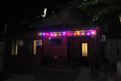 a house with purple lights on the roof at night at Tbilisi Stories Hotel in Tbilisi City