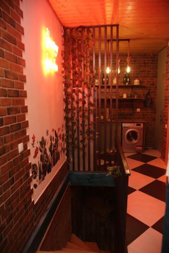 a room with a red brick wall and a staircase at Tbilisi Stories Hotel in Tbilisi City