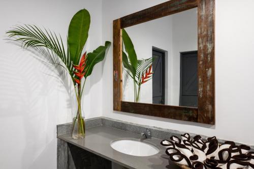 a bathroom with a sink and a mirror at Casa Beach Hotel "Casa Del Mar" in Jambiani