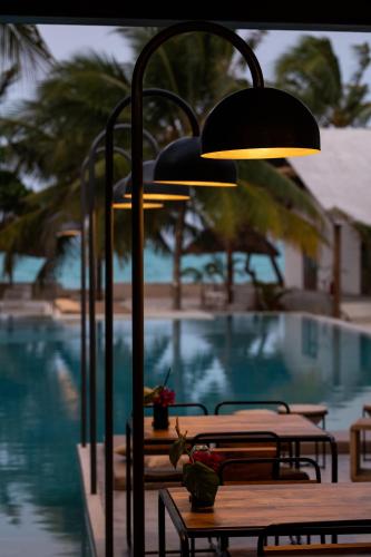 a light on a table next to a pool at Casa Beach Hotel "Casa Del Mar" in Jambiani