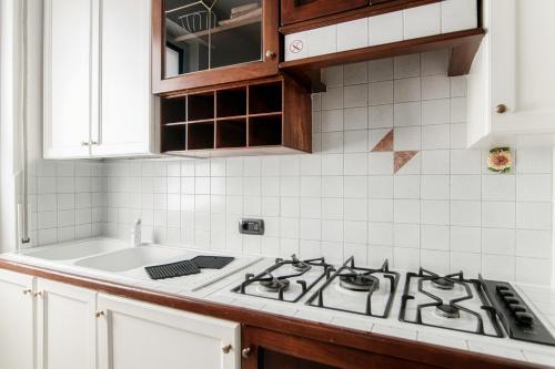 a kitchen with a stove and a sink at Till Now - by My Home In Como in Como