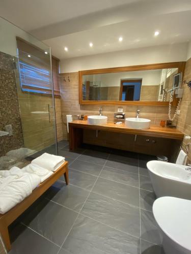 a bathroom with two sinks and a shower at Card International Hotel in Rimini