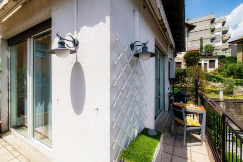a white wall with two lights on a balcony at Till Now - by My Home In Como in Como