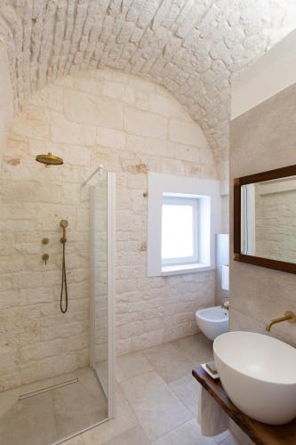a bathroom with a white sink and a shower at Terrazze Sulla Valle in Martina Franca