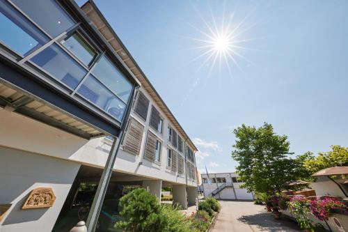 a building with the sun in the sky at Hotel Am Kamin in Kaufbeuren