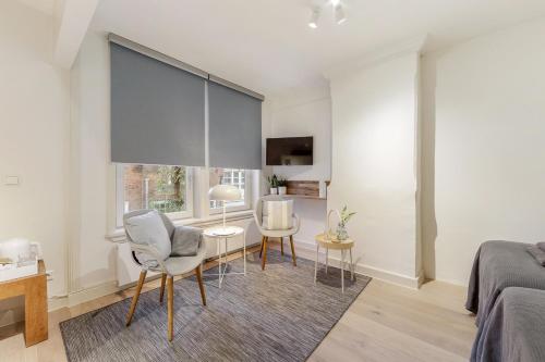 a bedroom with a bed and a table and chairs at Adam's Suite in Amsterdam