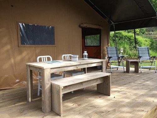 a wooden table and chairs on a patio at Tenuta Tredici Ulivi in Senigallia