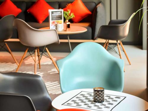 a room with chairs and a table with a chessboard at Ibis Brussels Erasmus in Brussels