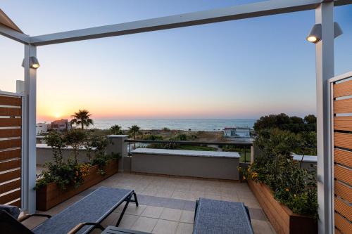 a balcony with a view of the ocean at Adele Riva in Adelianos Kampos