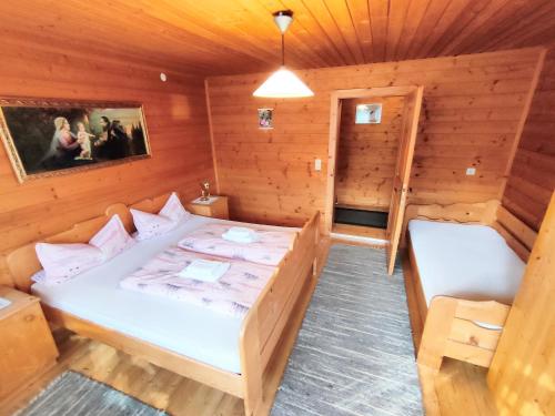 a room with a bed in a wooden room at Ferienwohnung Gassenhof in Matrei in Osttirol