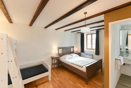 a bedroom with a bed and a ladder in it at Auberge La Plaine in Chabrillan