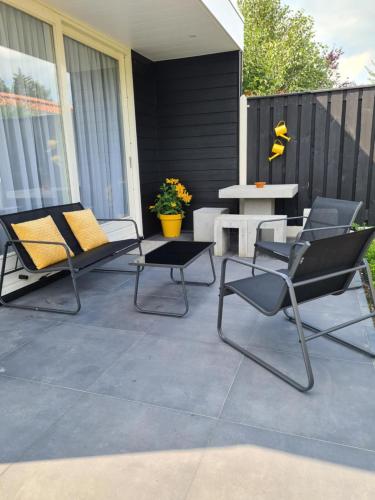 two chairs and a table on a patio at Tip Top Studio Vlissingen in Vlissingen