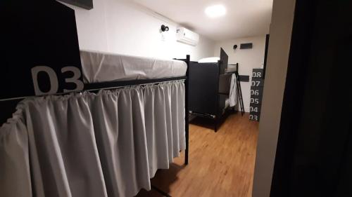 a room with a row of grey curtains at Hostel More SP in Sao Paulo